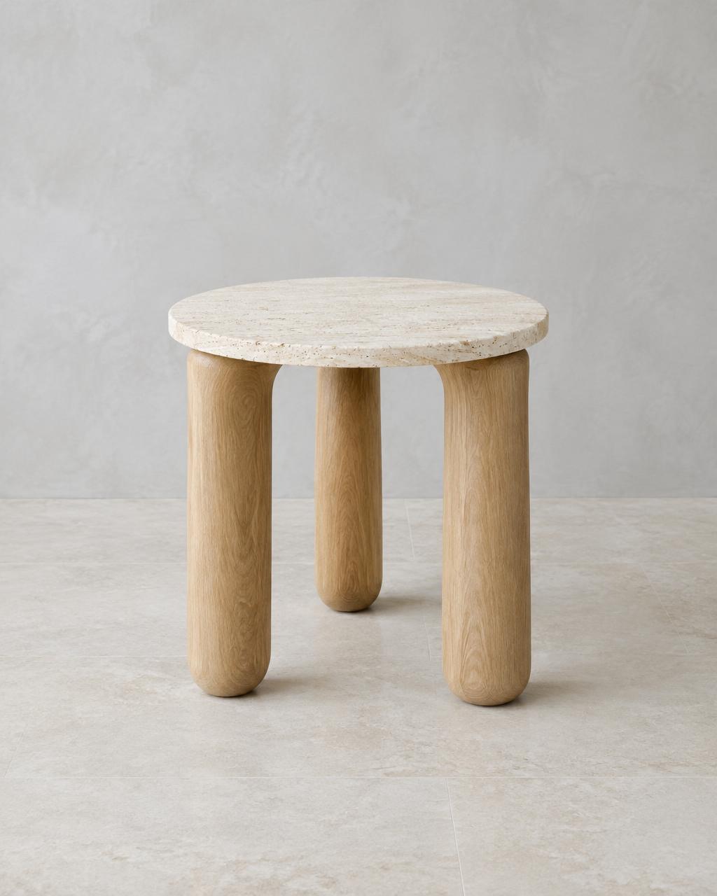 Haven Side Table with a round travertine top and three sculptural solid oak legs, shown in full